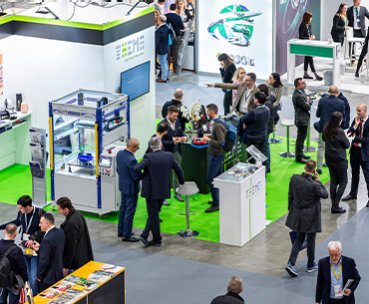 Exhibitors and visitors meet on a stand at Fastener Fair Italy